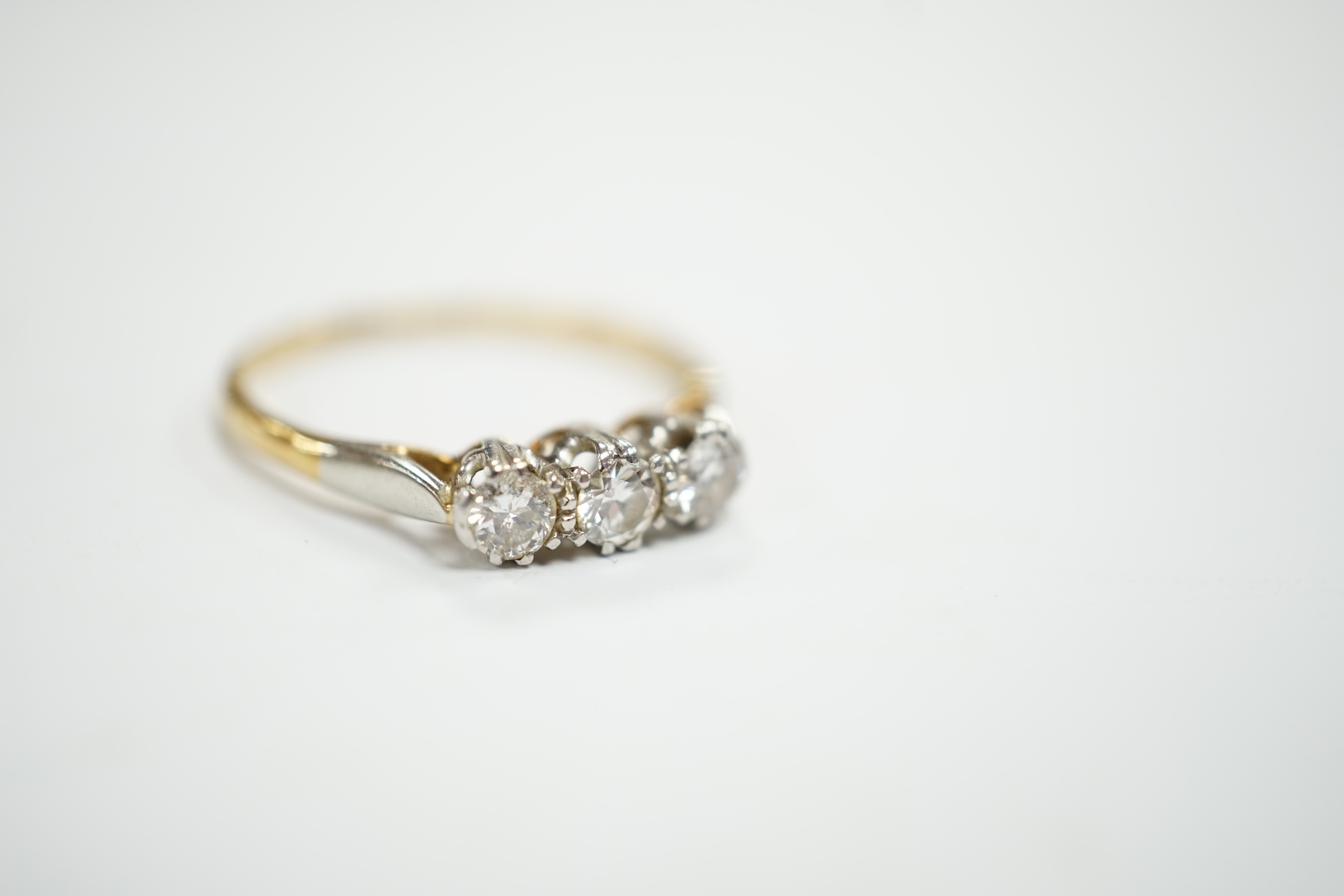 An 18ct, plat and three stone diamond set ring, size P/Q, size 2.6 grams.